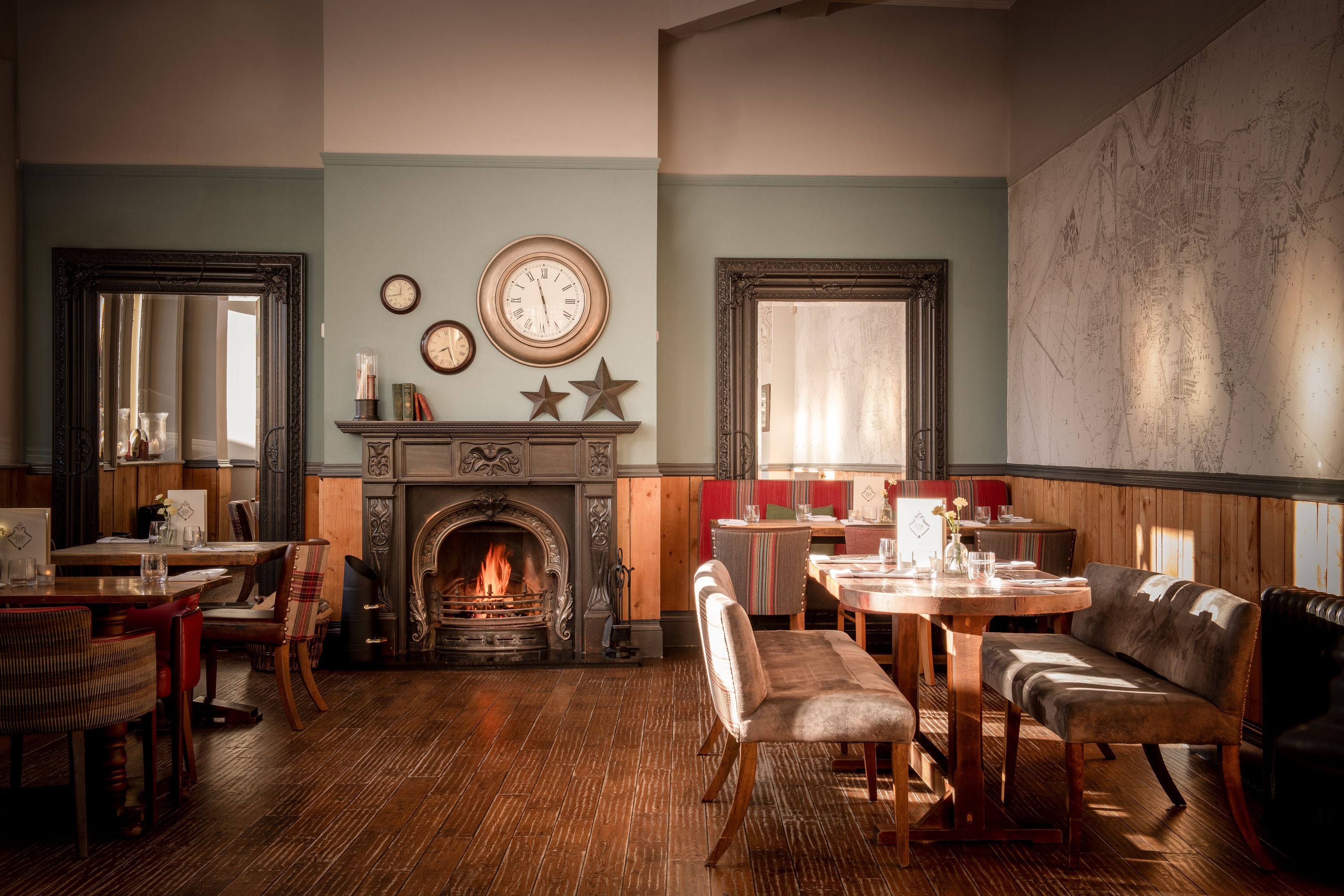 restaurant seating with open fire and wooden chairs