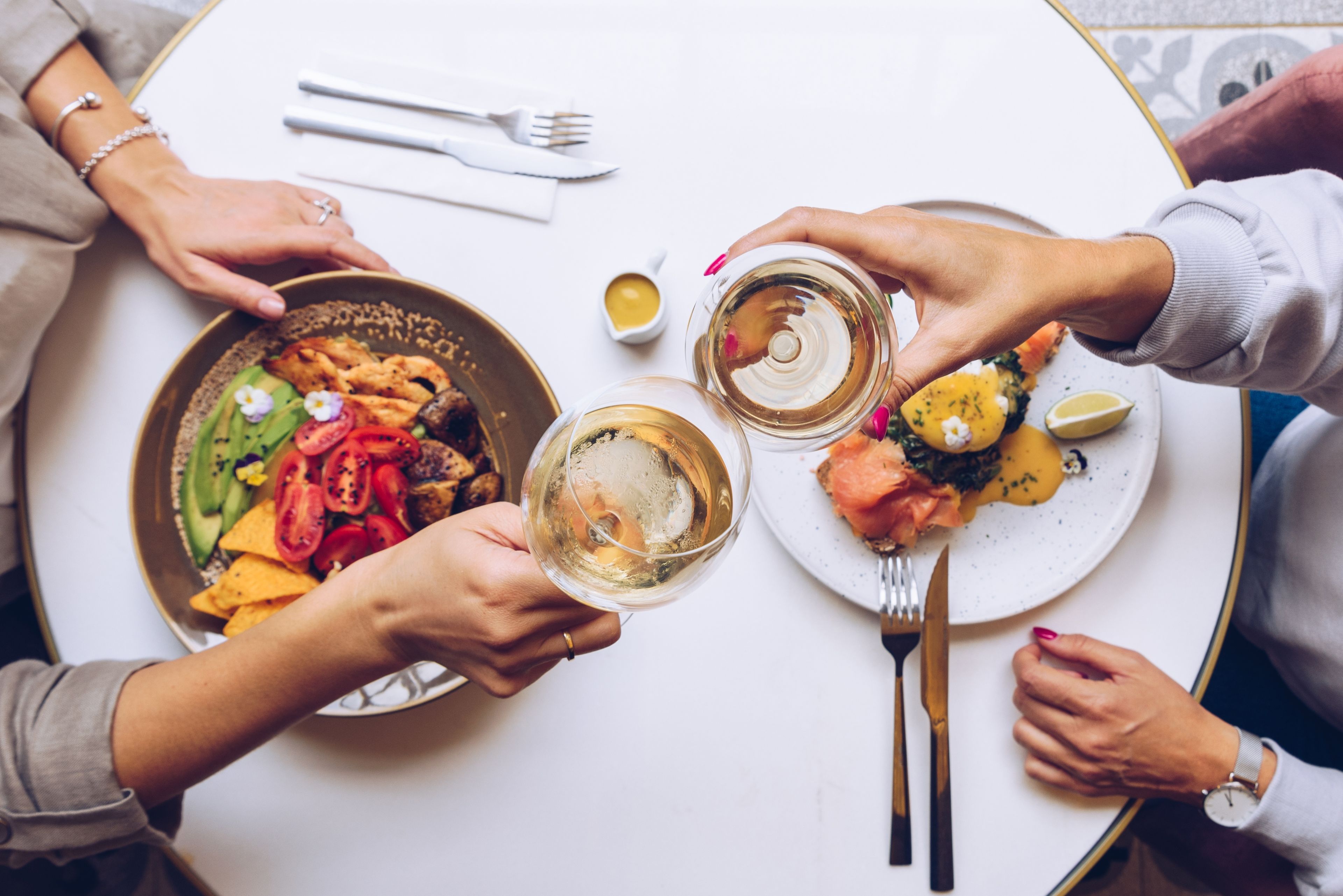 two people dining for brunch with a glass of prosecco