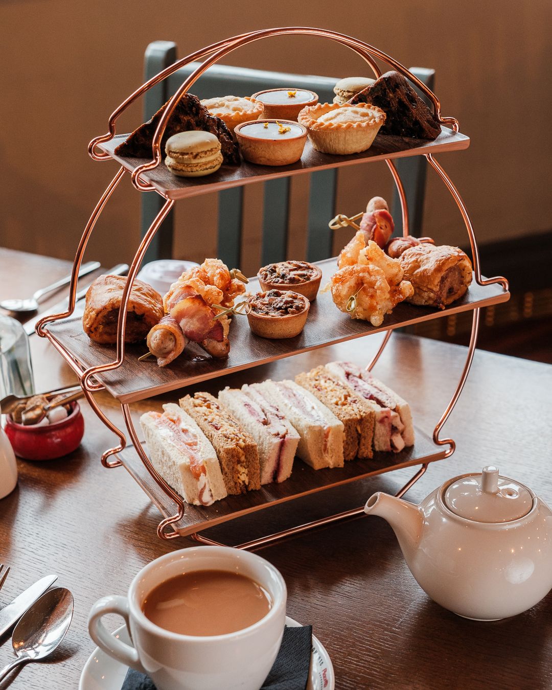 afternoon tea stand with a pot of tea